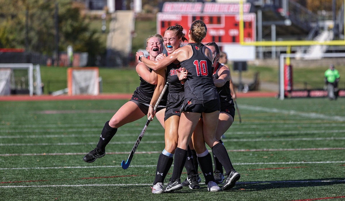 Field hockey team members embrace celebrating