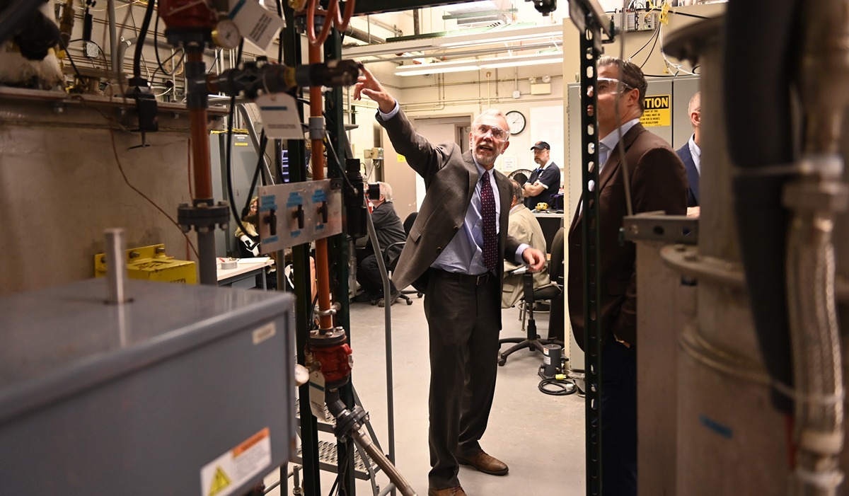 Physics Professor Ian Pegg leads a tour of the Vitreous State Laboratory , where he serves as director.