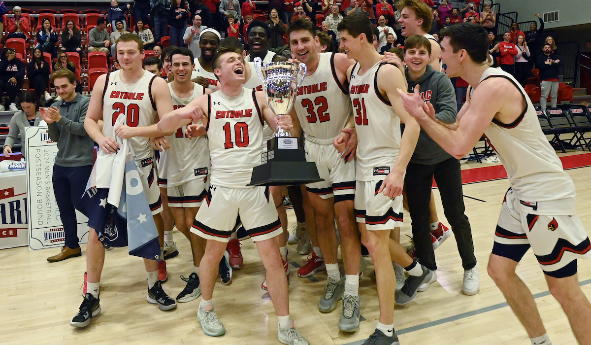 men's basketball team celebrating after a win