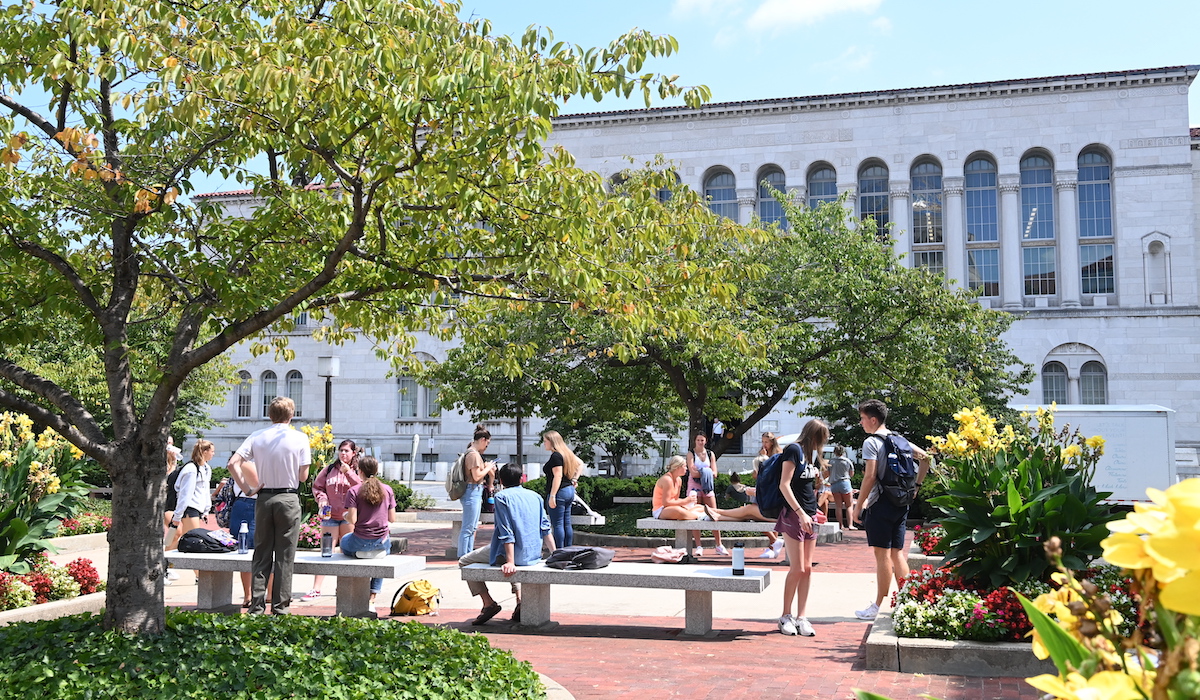 students hanging out on a beautiful plaza on campus