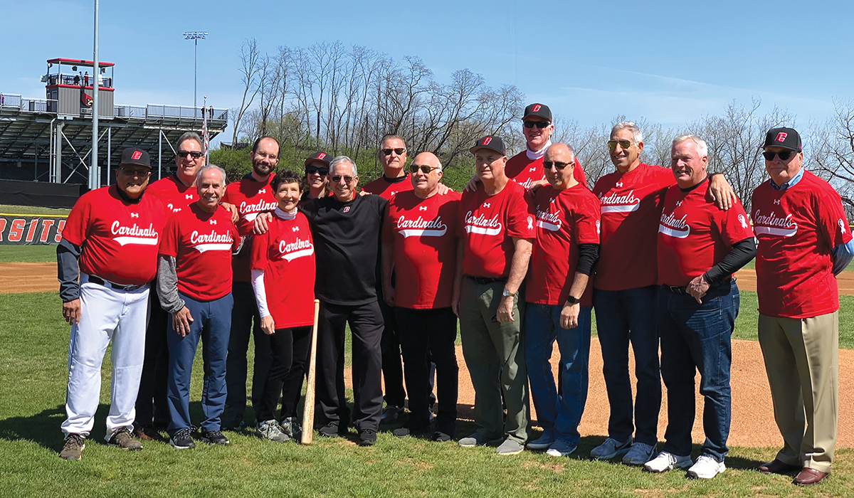 Matt Kurkjian surrounded by friends and family at Catholic University baseball event where everyone wore t-shirts that had Matt’s #2 on the back.