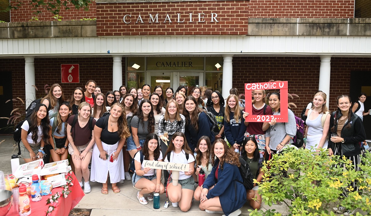 Many students posing in front of their residence hall