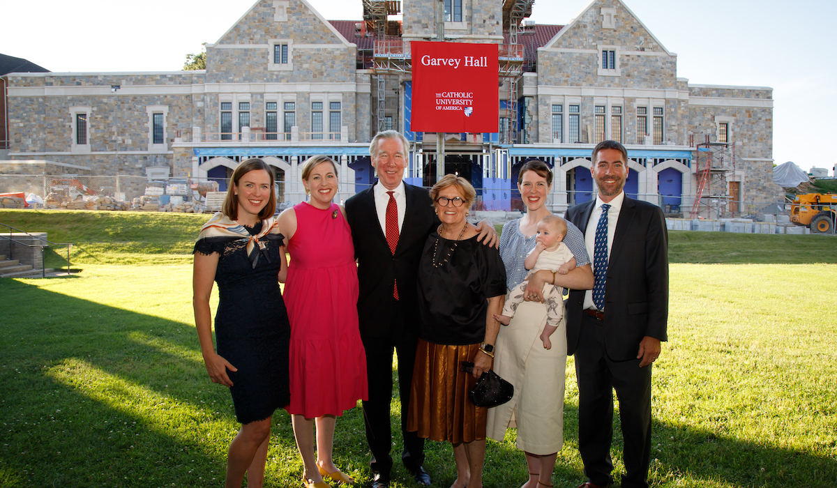 President Garvey in front of Garvey Hall with his family