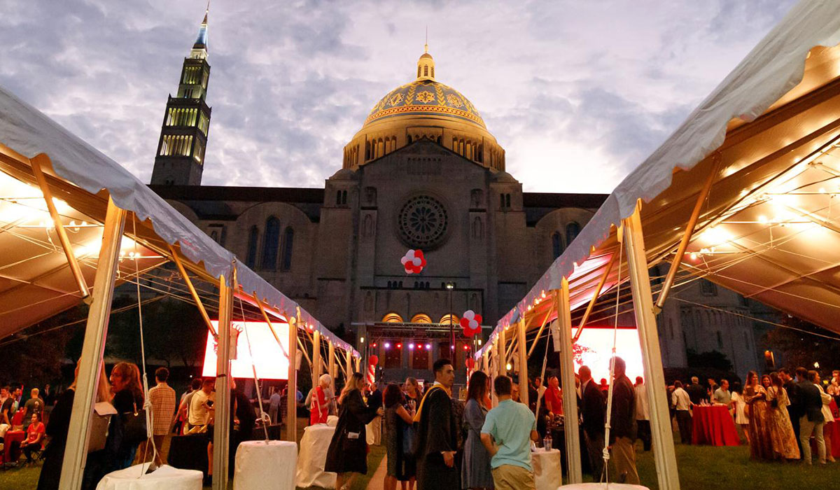 Exterior of the basilica during a student event with pavilions