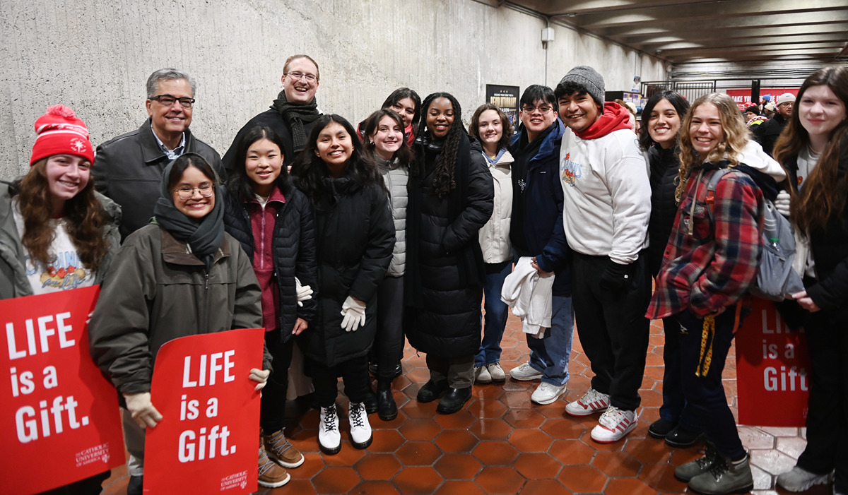 University President Peter Kilpatrick gathered at a Metro station with students heading to the March for Life.