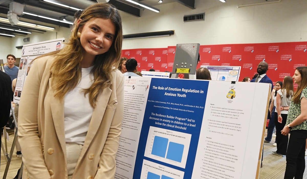 Mary Fallon enjoys a moment in front of her award-winning poster presentation. 