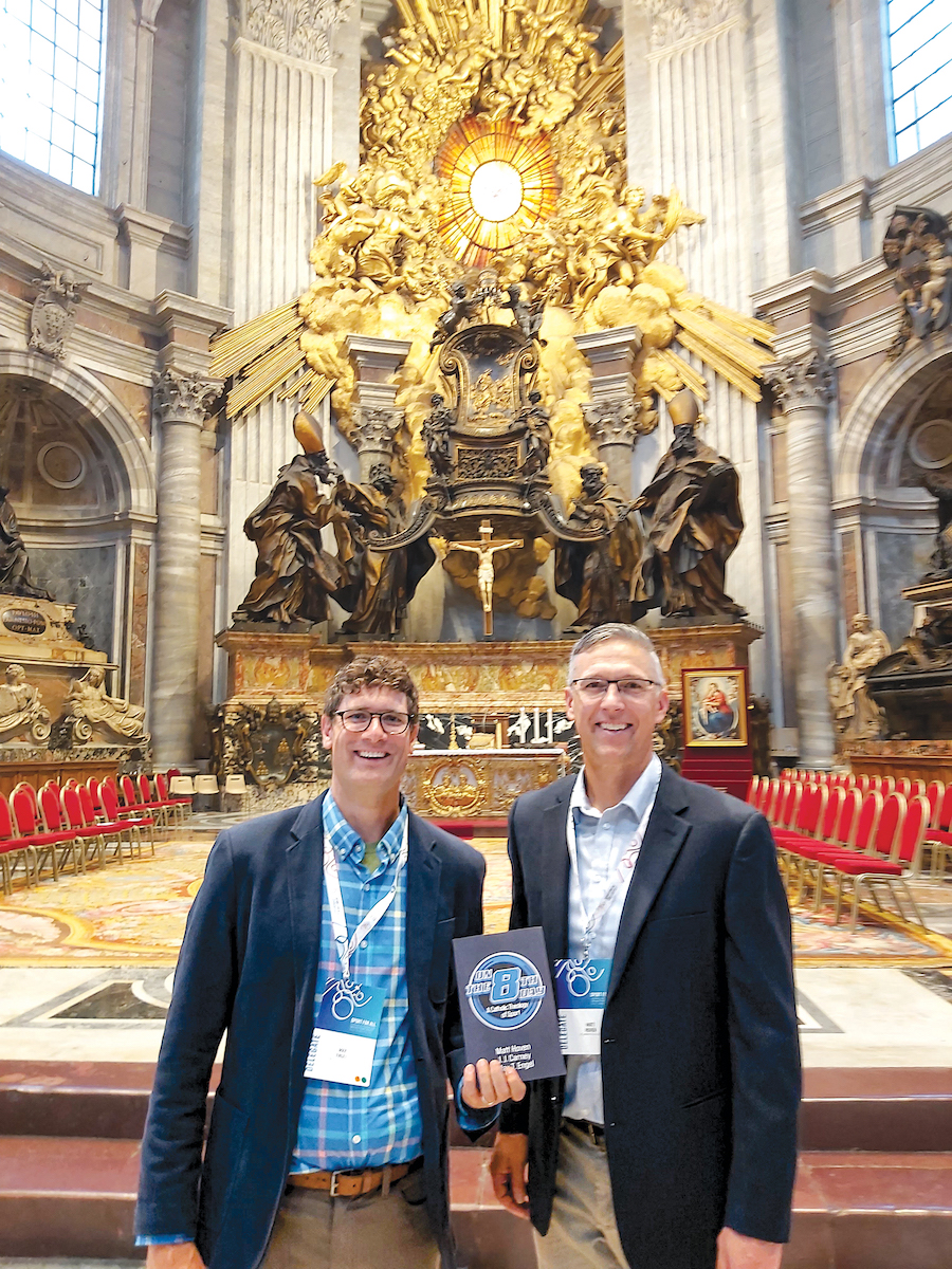 Max Engel (left), and Matt Hoven (right) in St. Peter's Basilica holding their book