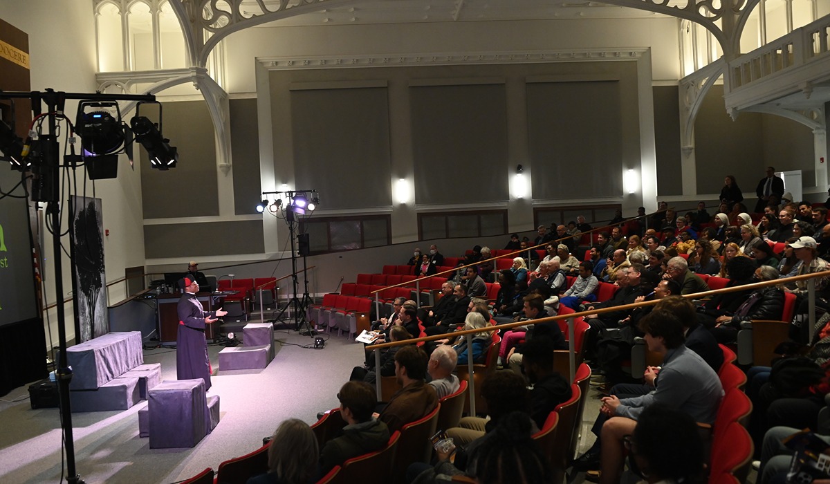 Jim Coleman, who plays Father Augustus Tolton, speaks to the crowd who gathered to see the performance.