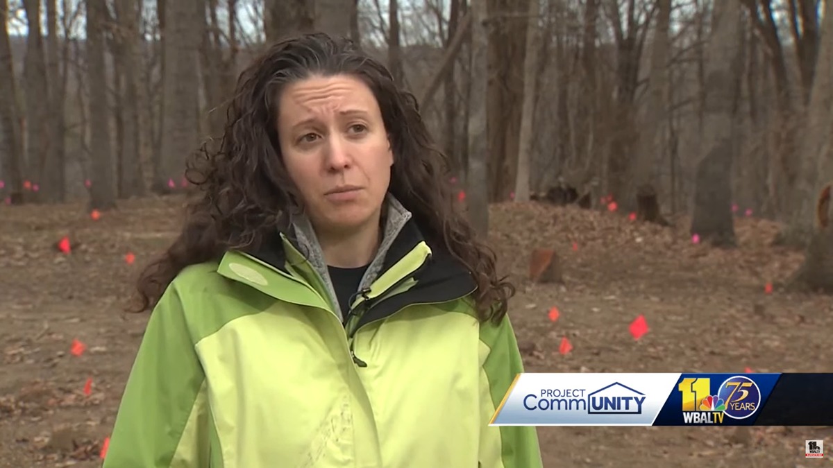 Person in a green jacket interviewed on camera