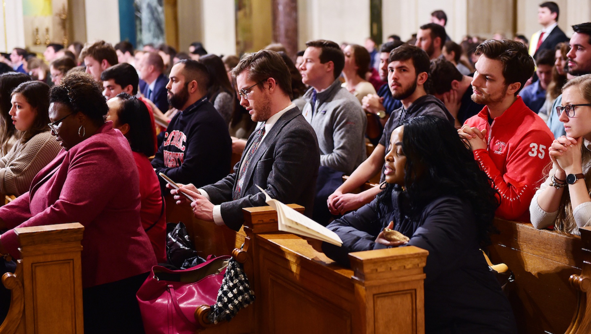 students praying at mass