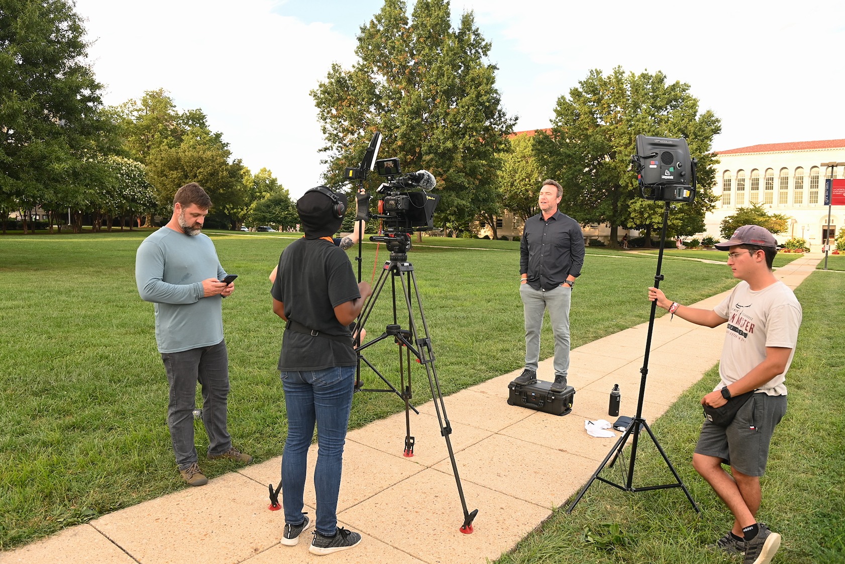 camera crew filming something on campus