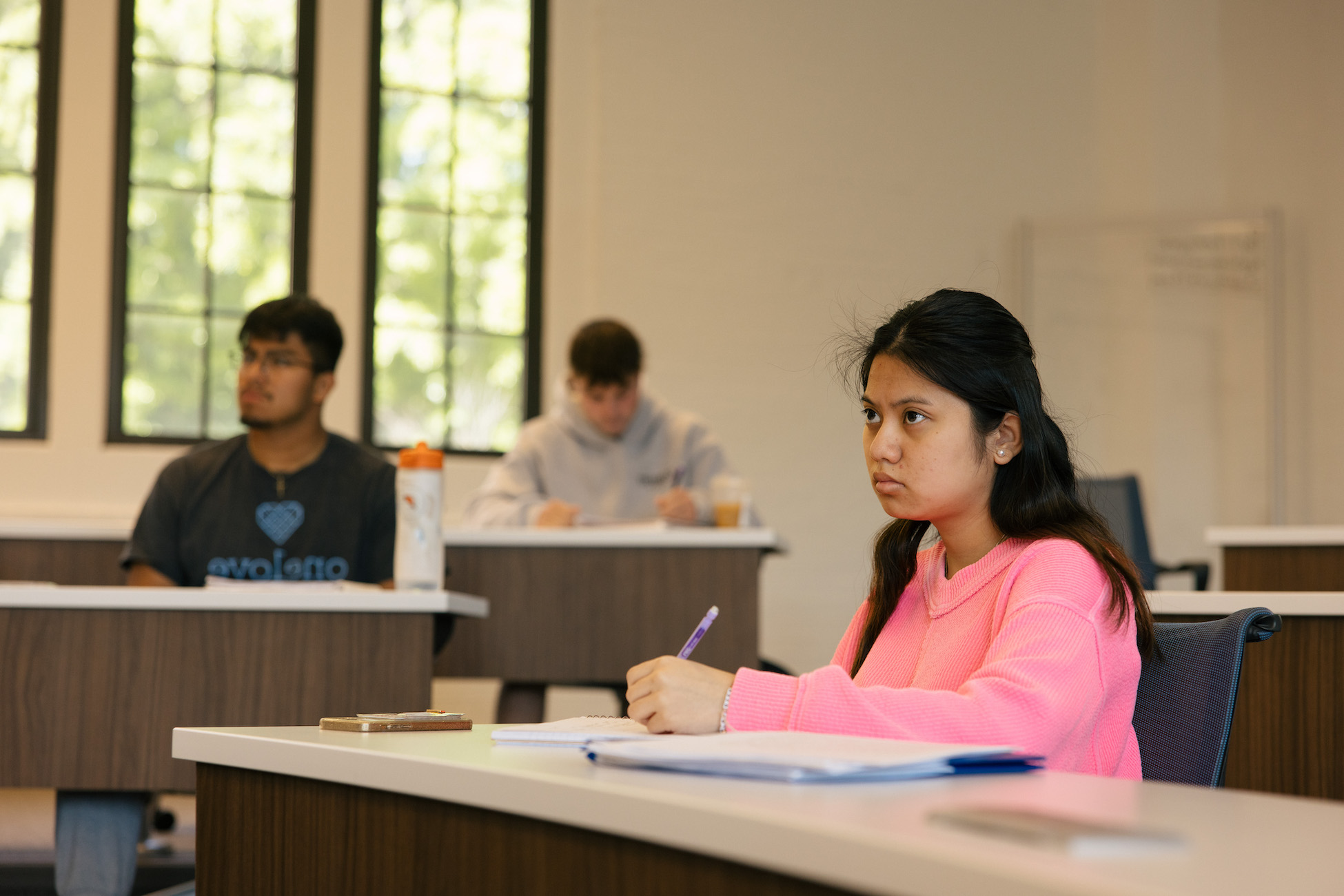 student taking notes in class