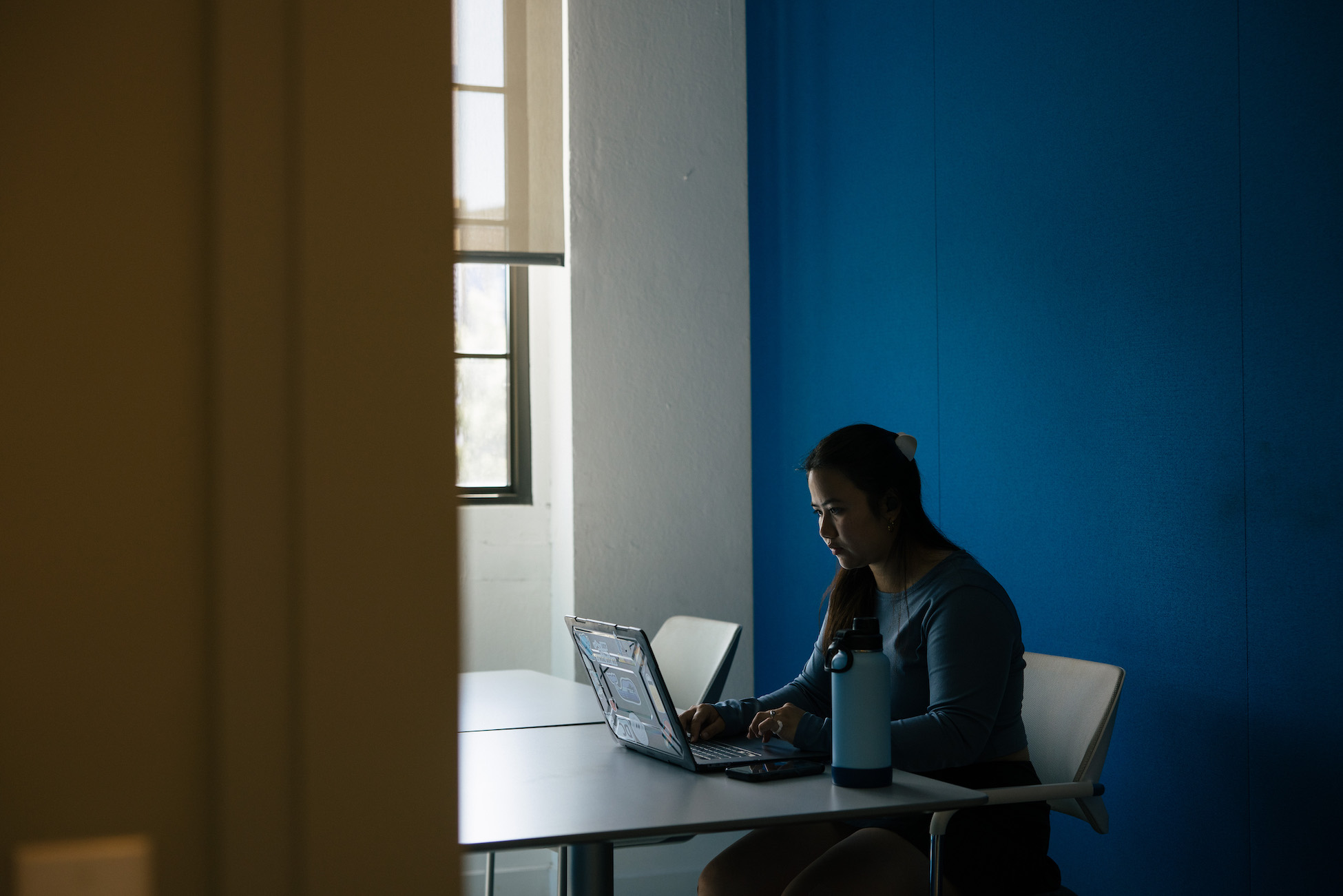 student working on her laptop