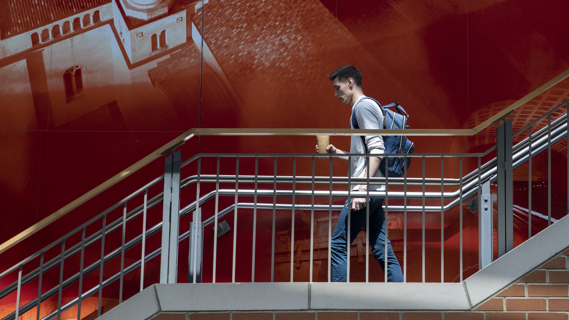 student walking down steps on campus