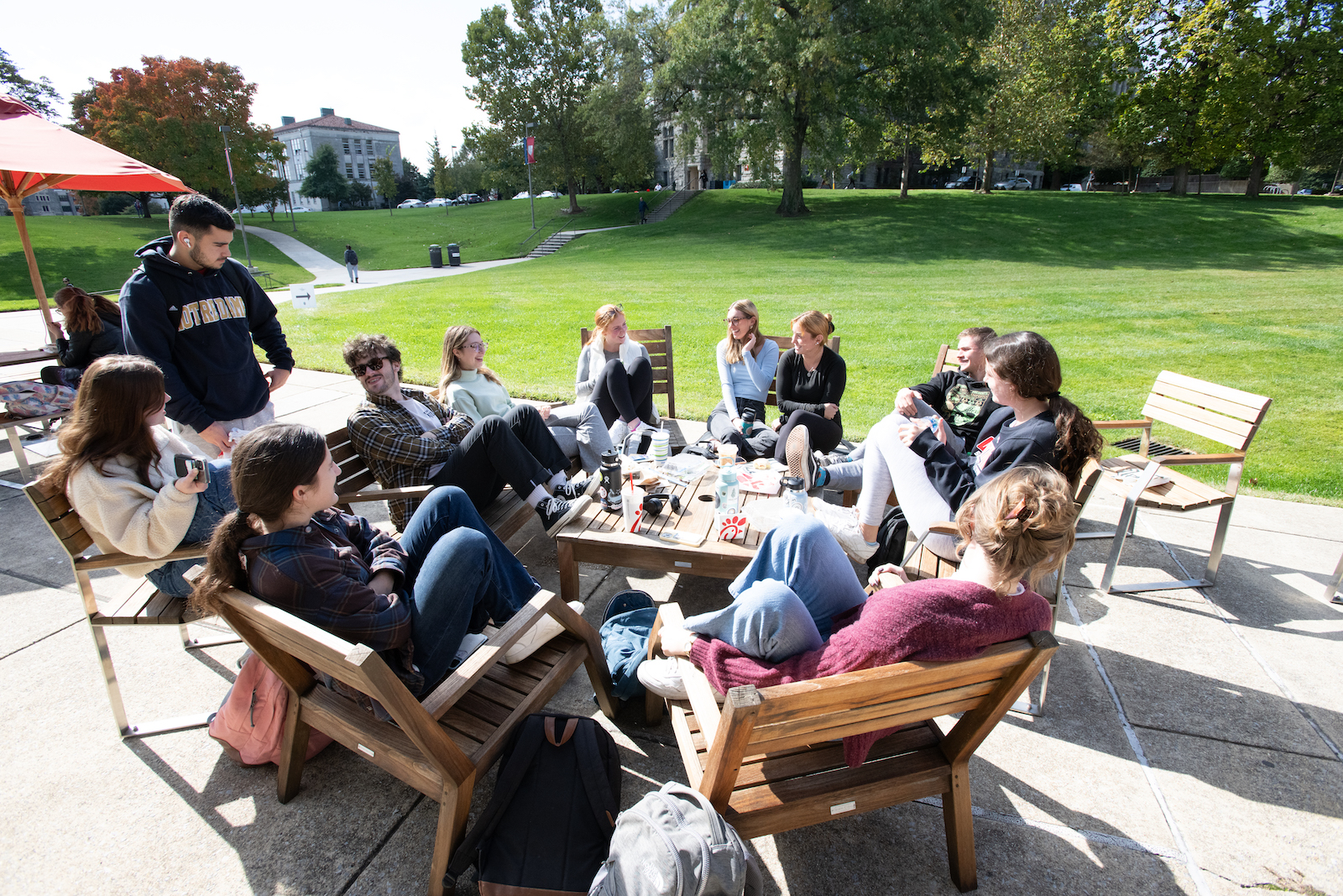 students talking in a circle on campus