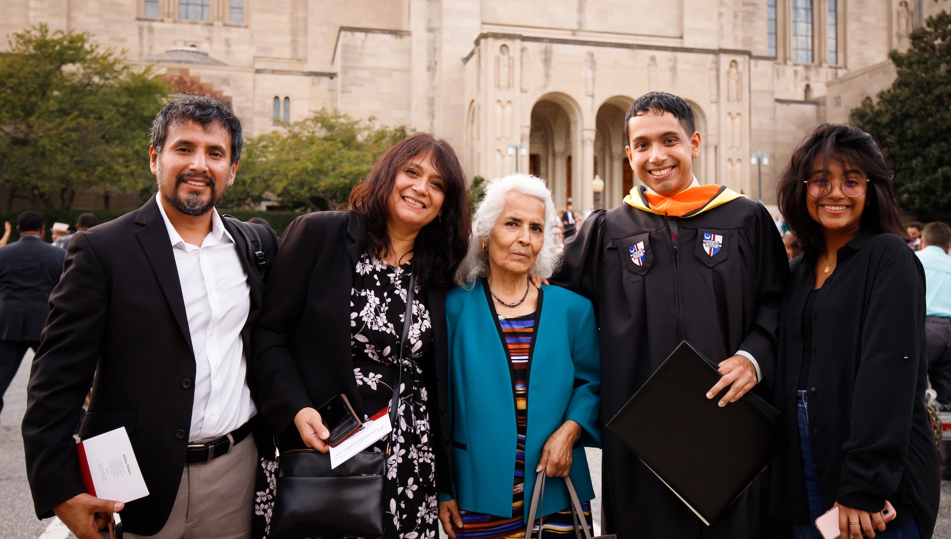 family posing with their graduate at graduation