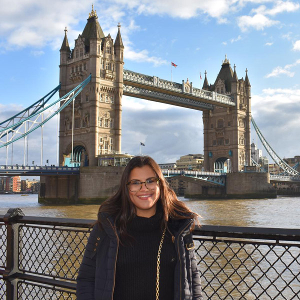 Student in front of the tower bridge in London