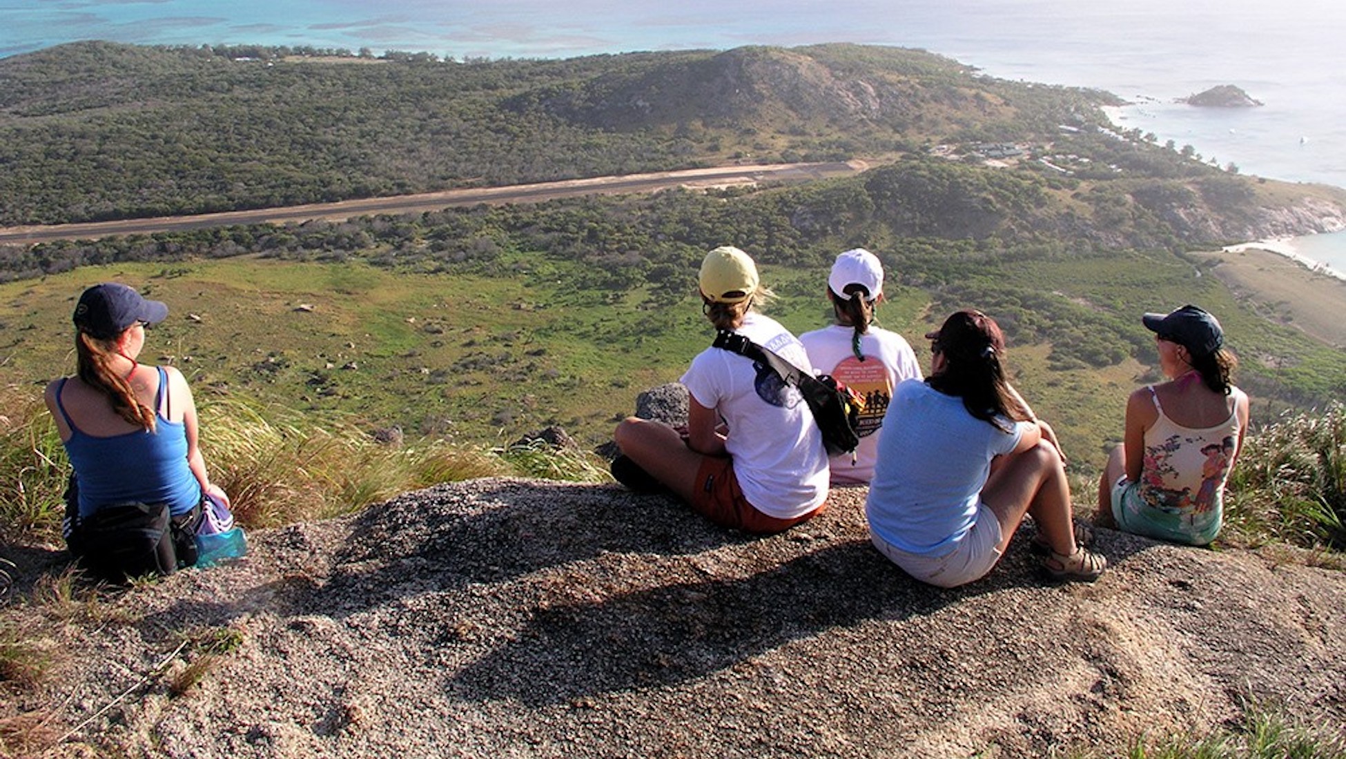 Students overlooking the Australian coastline from a cliff