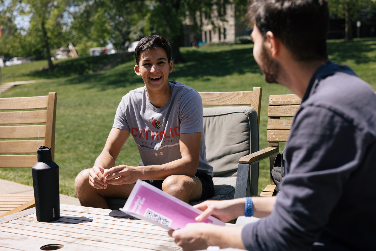 boys smiling and chatting on campus