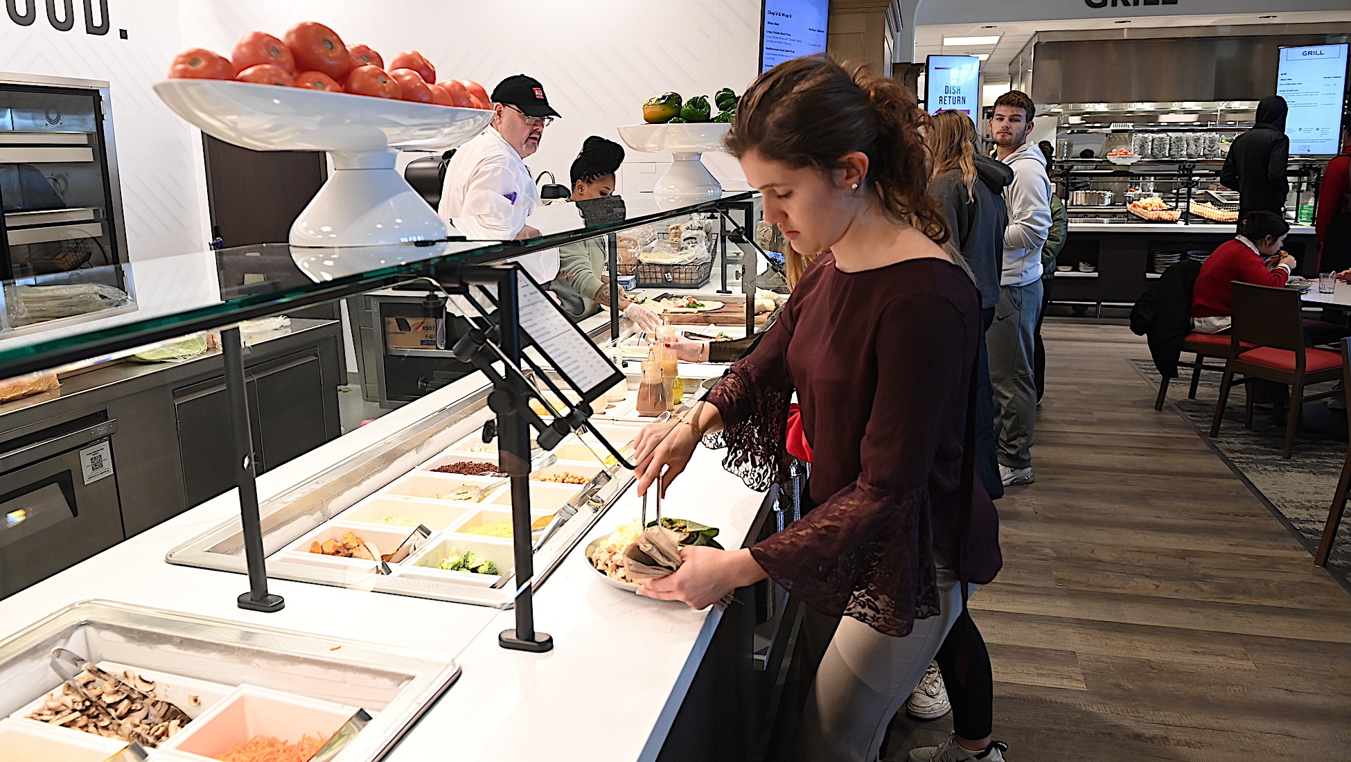 student serving herself a salad in Garvey Hall