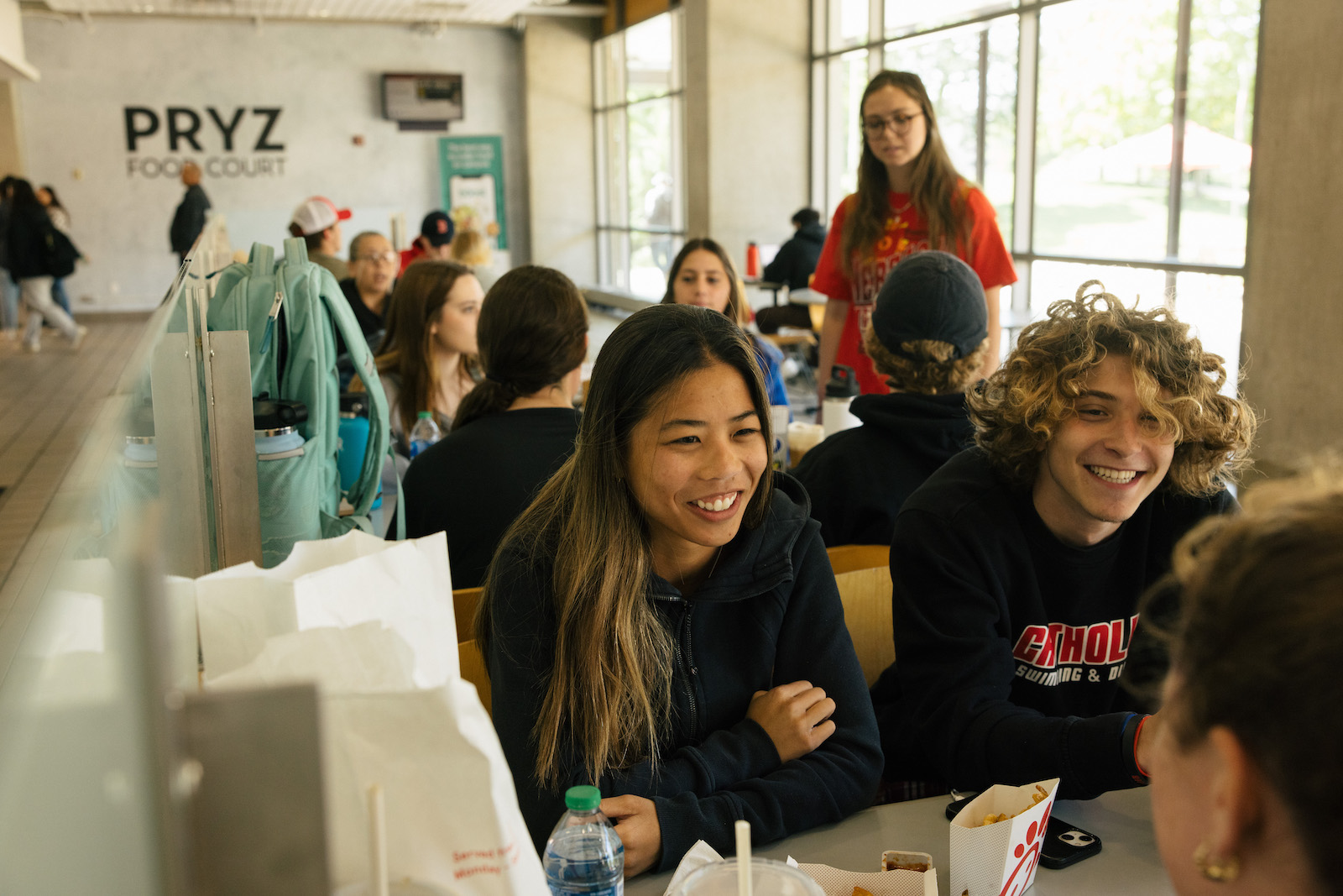 students laughing as they have lunch together