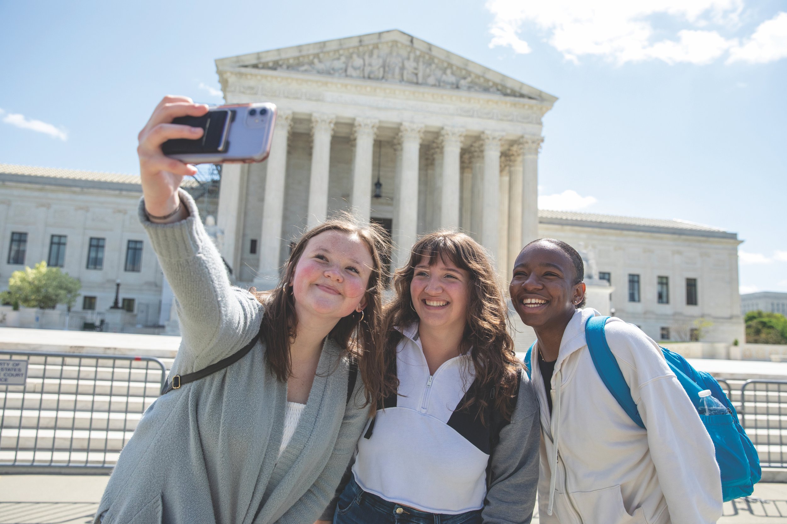 girls take a selfie in front of the U.S. Supreme Court