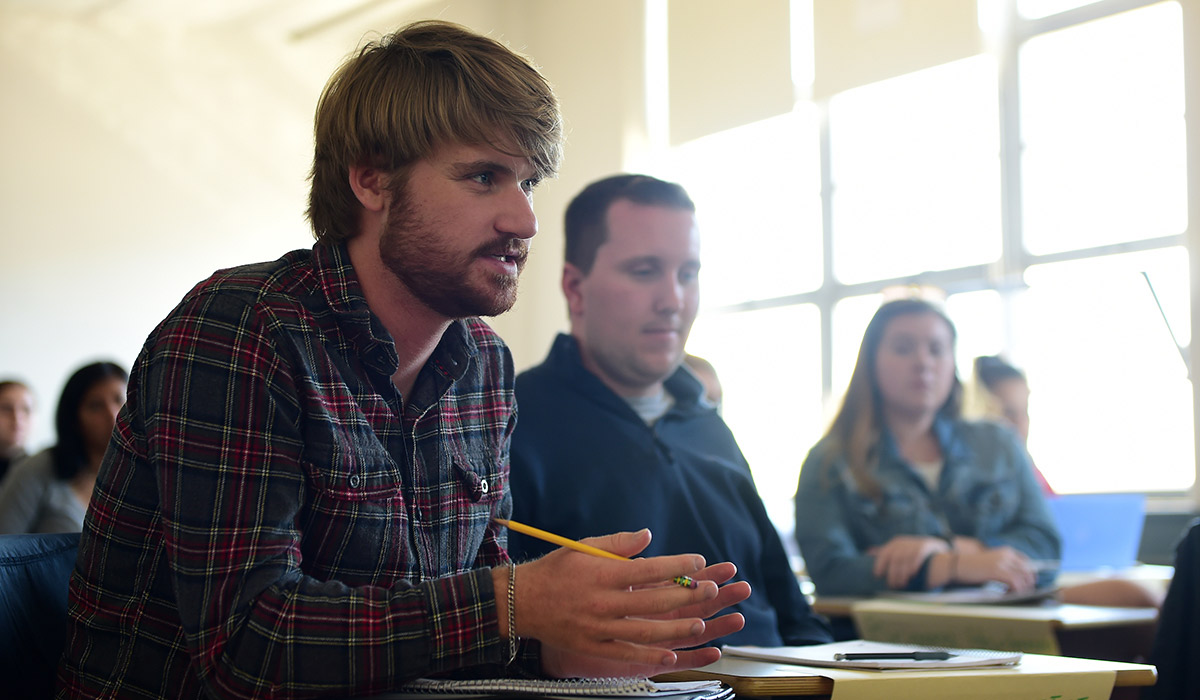 bearded student looking up at a lesson