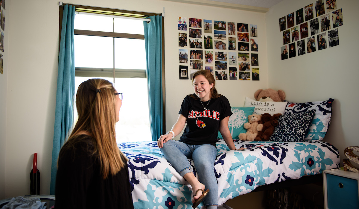 students chatting in their dorm room