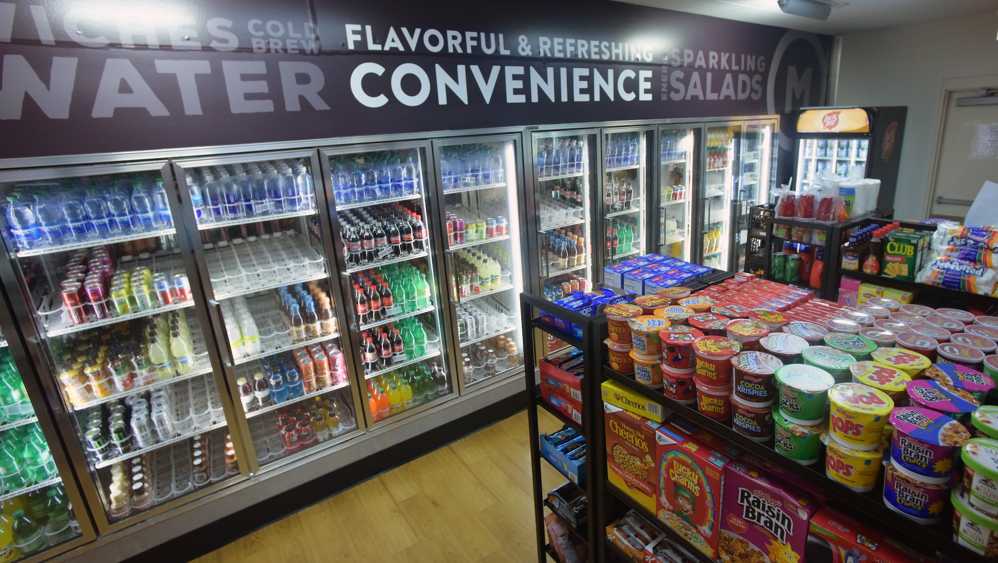 shelves and refrigerators stocked with snacks at the pryz market