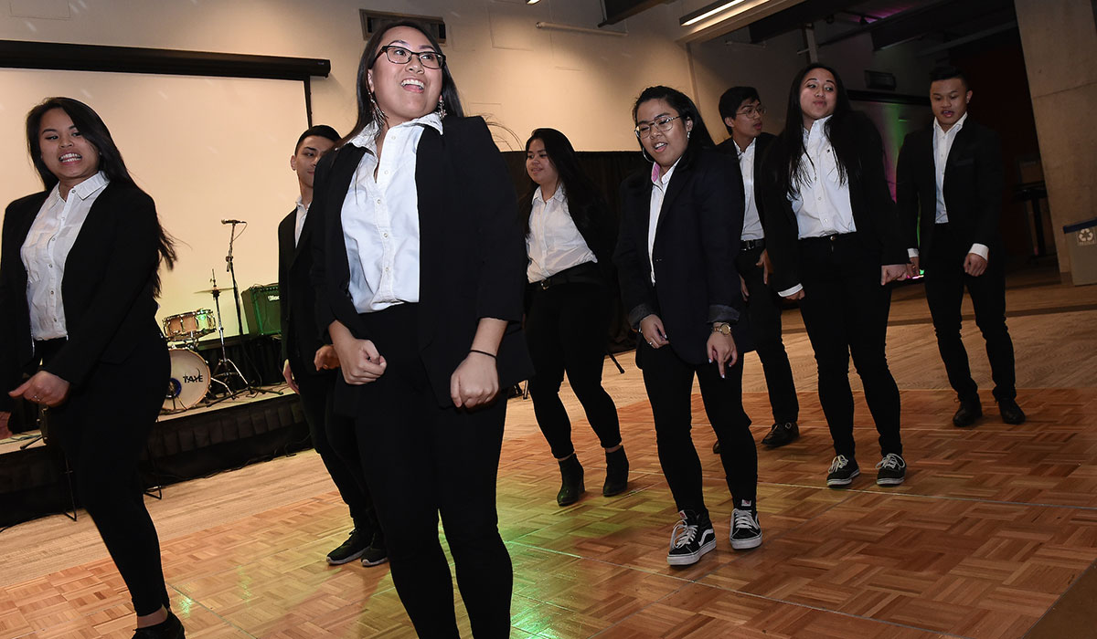 filipino students performing a dance on campus