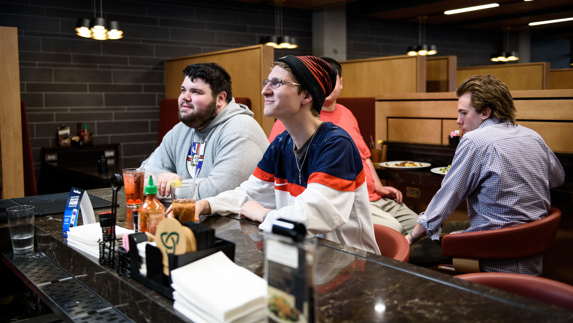 students watching a sports game at the bar at Murphy's Grill