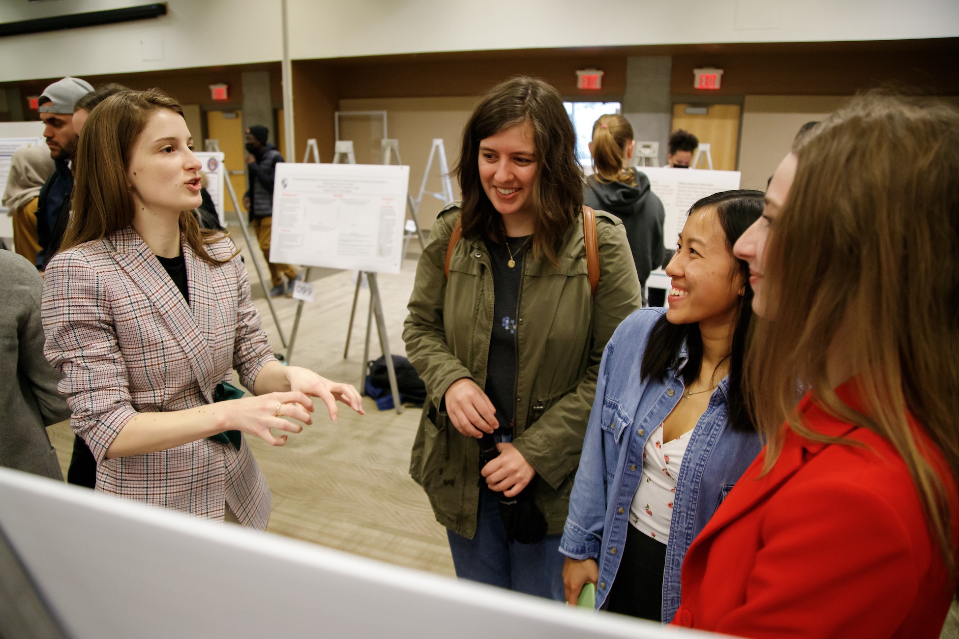 students listening attentively to a research day poster presentation