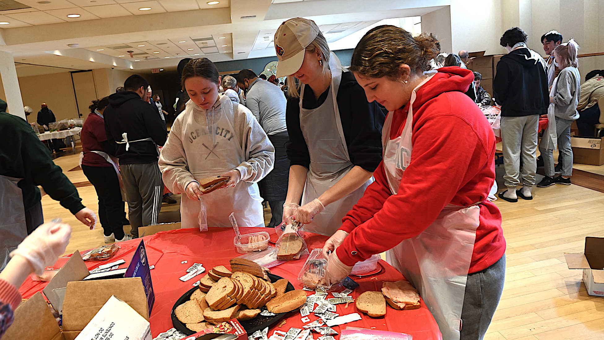 students make sandwiches on a university community service day