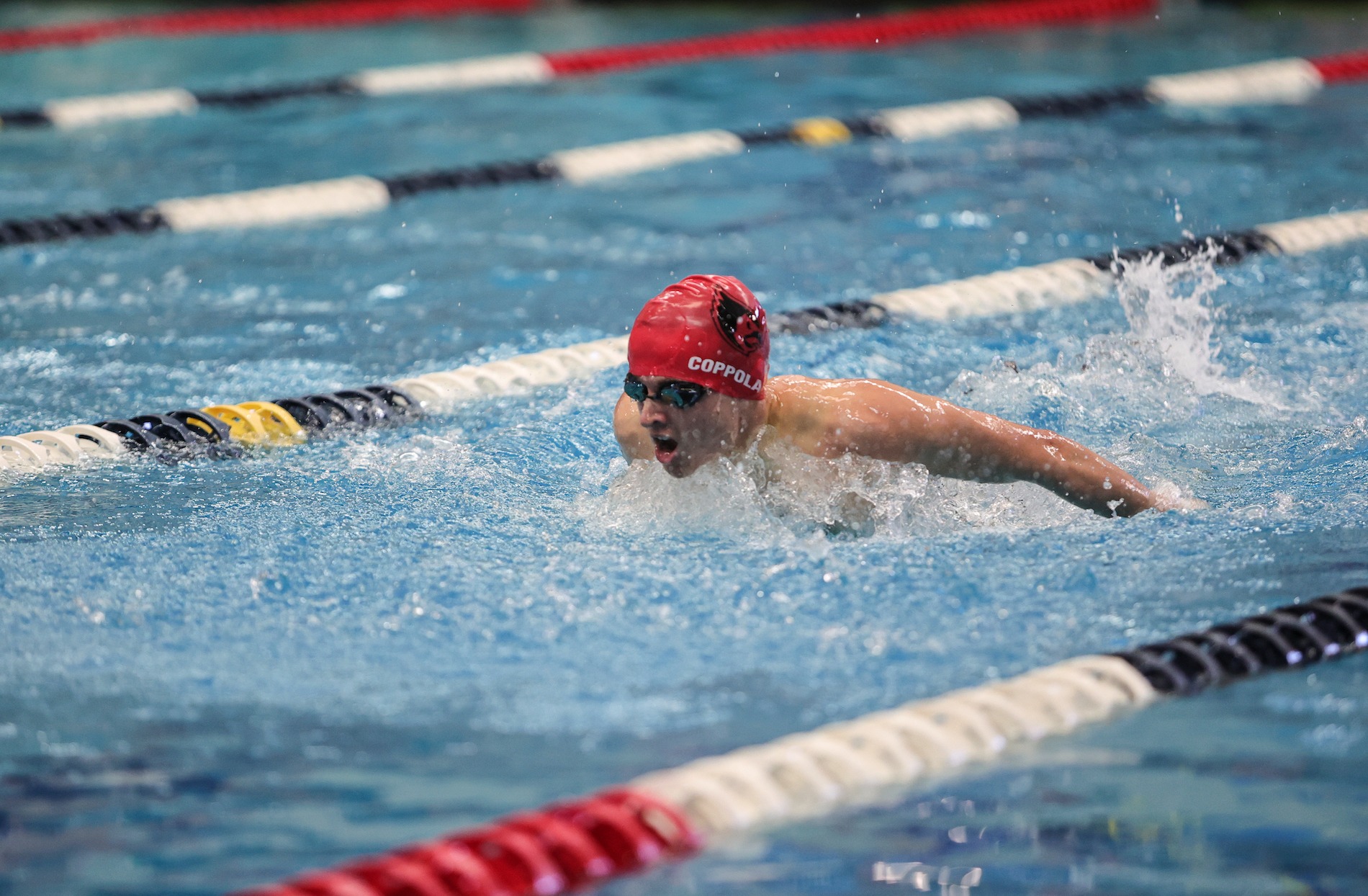 catholic university swimmer competing in a race