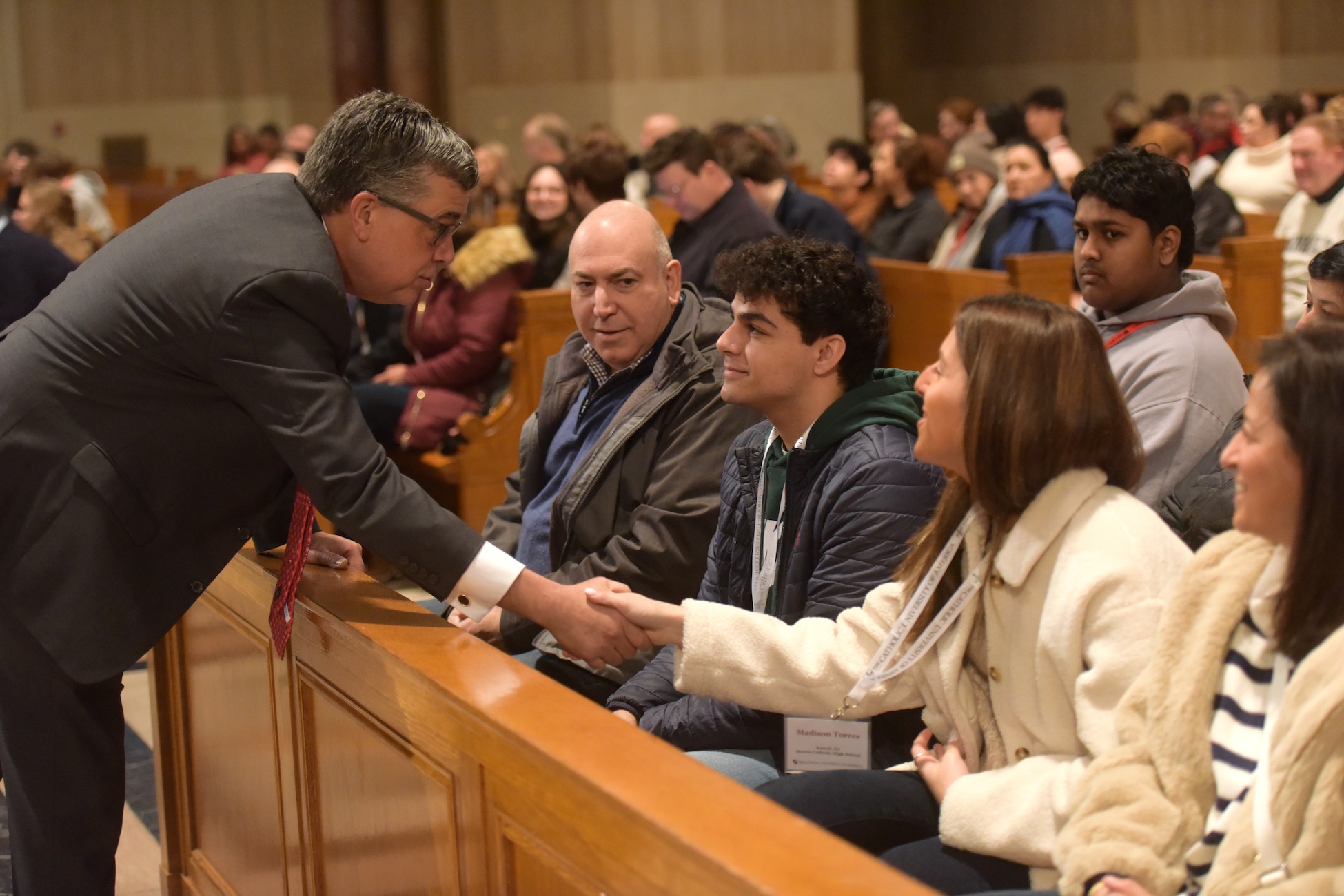 president kilpatrick shaking prospective student's hand at an admission event