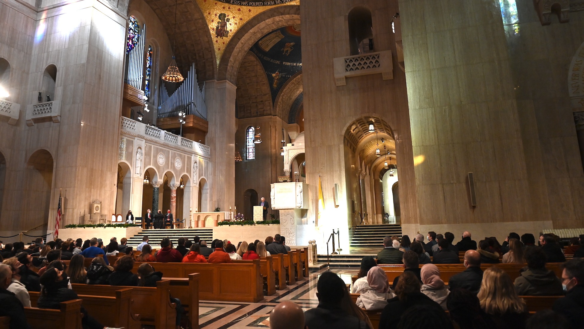 prospective students and families attend a session of cardinal preview day inside the basilica