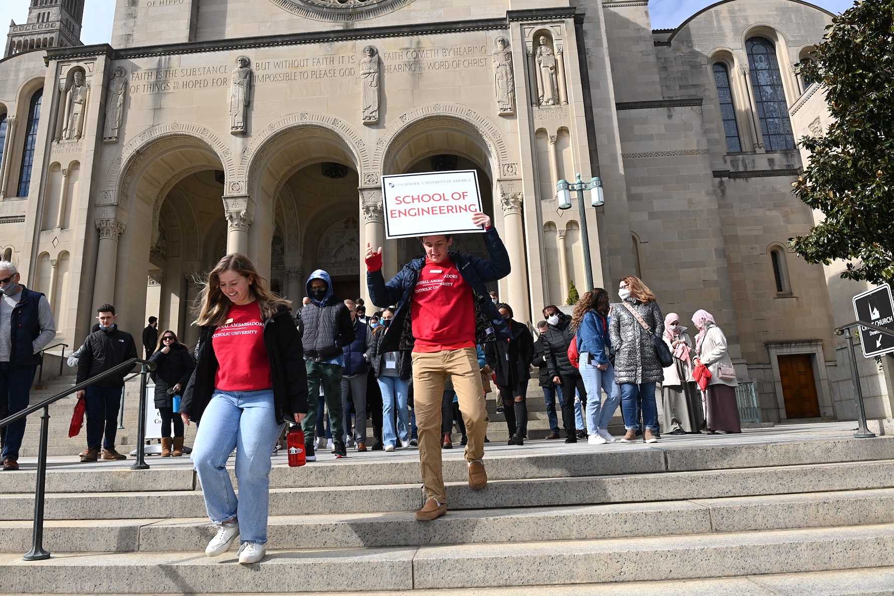 students walk down the steps of the basilica at cardinal preview day