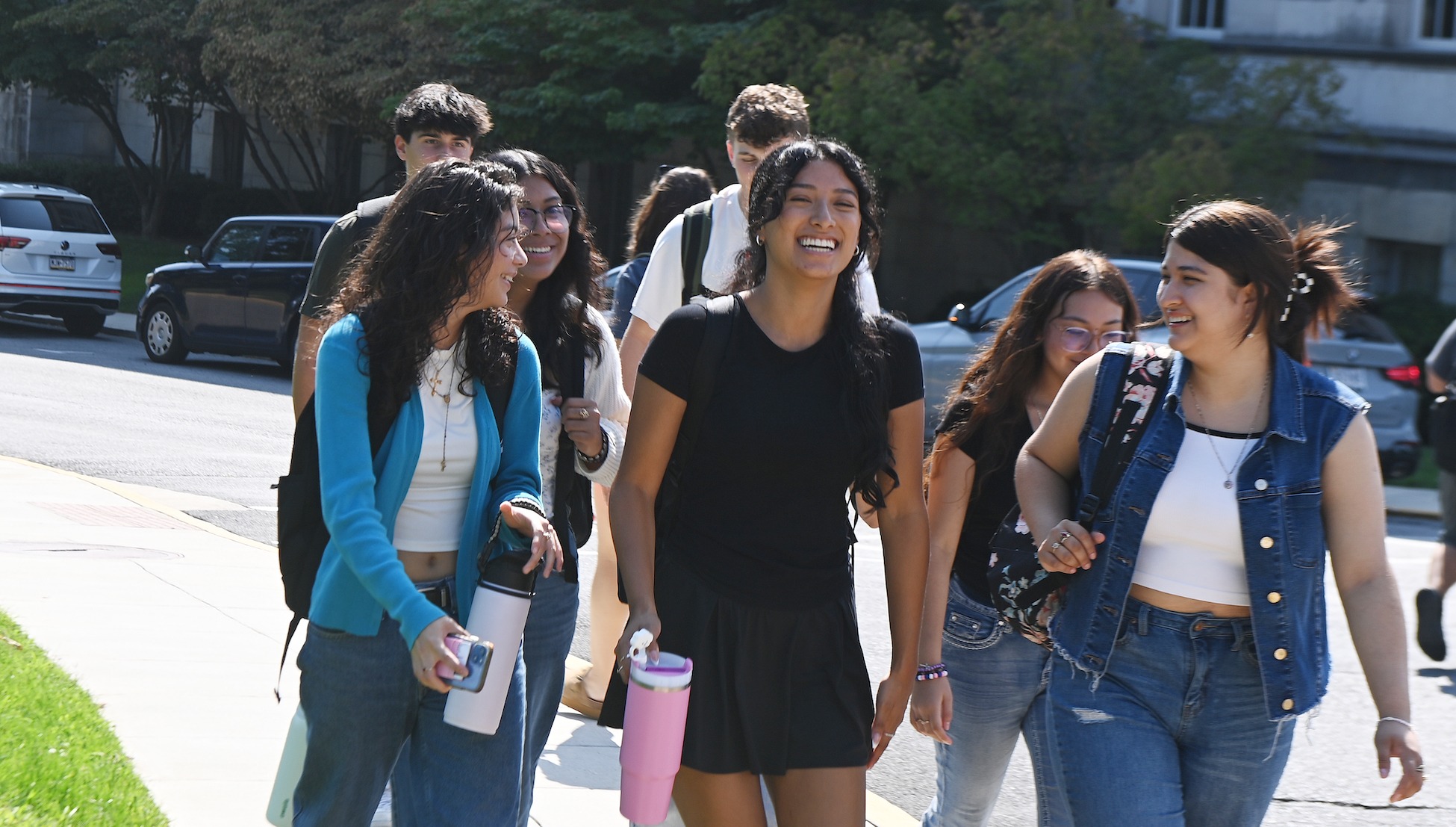 group of students laughing as they walk to class together