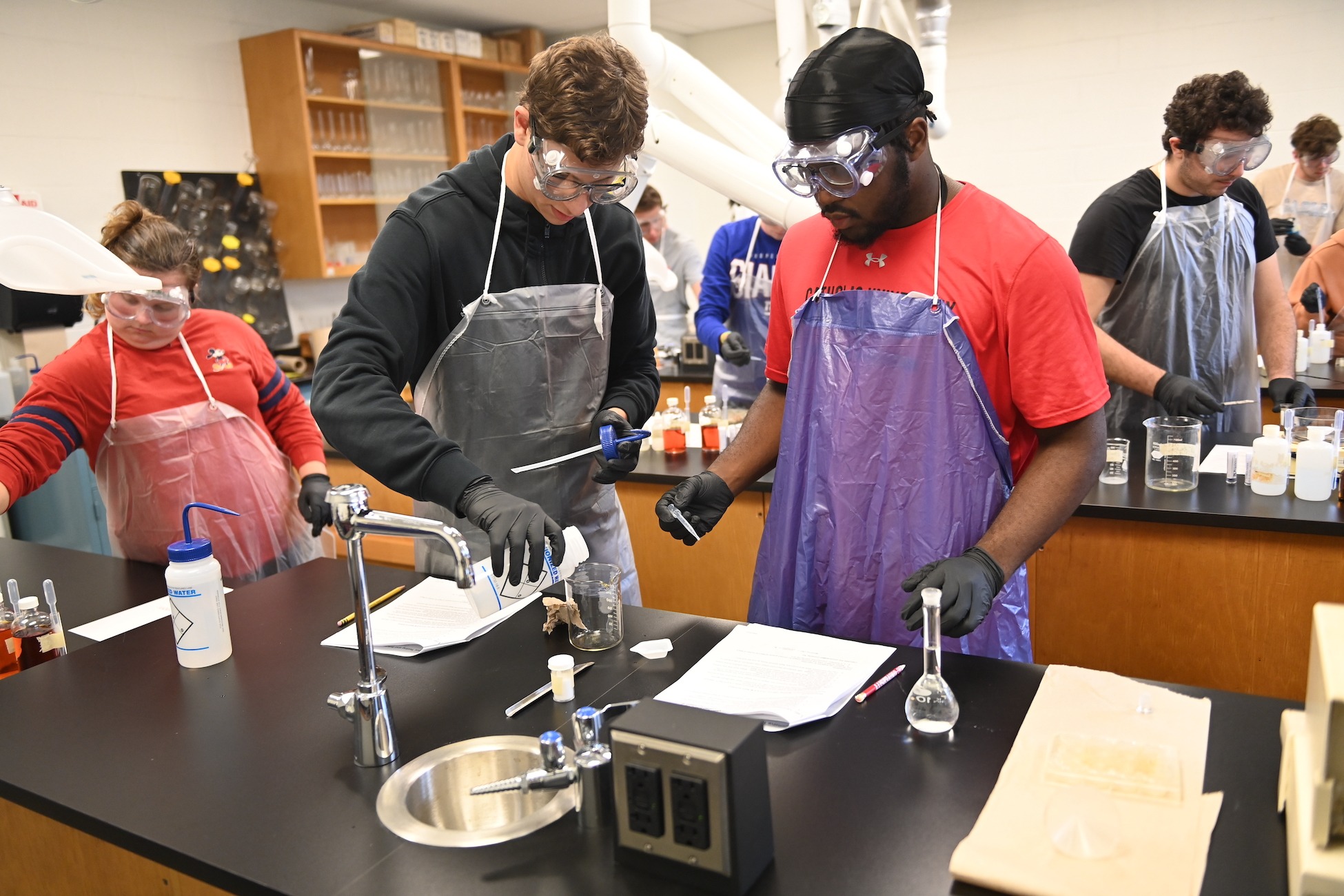 students conducting a chemistry experiment in class