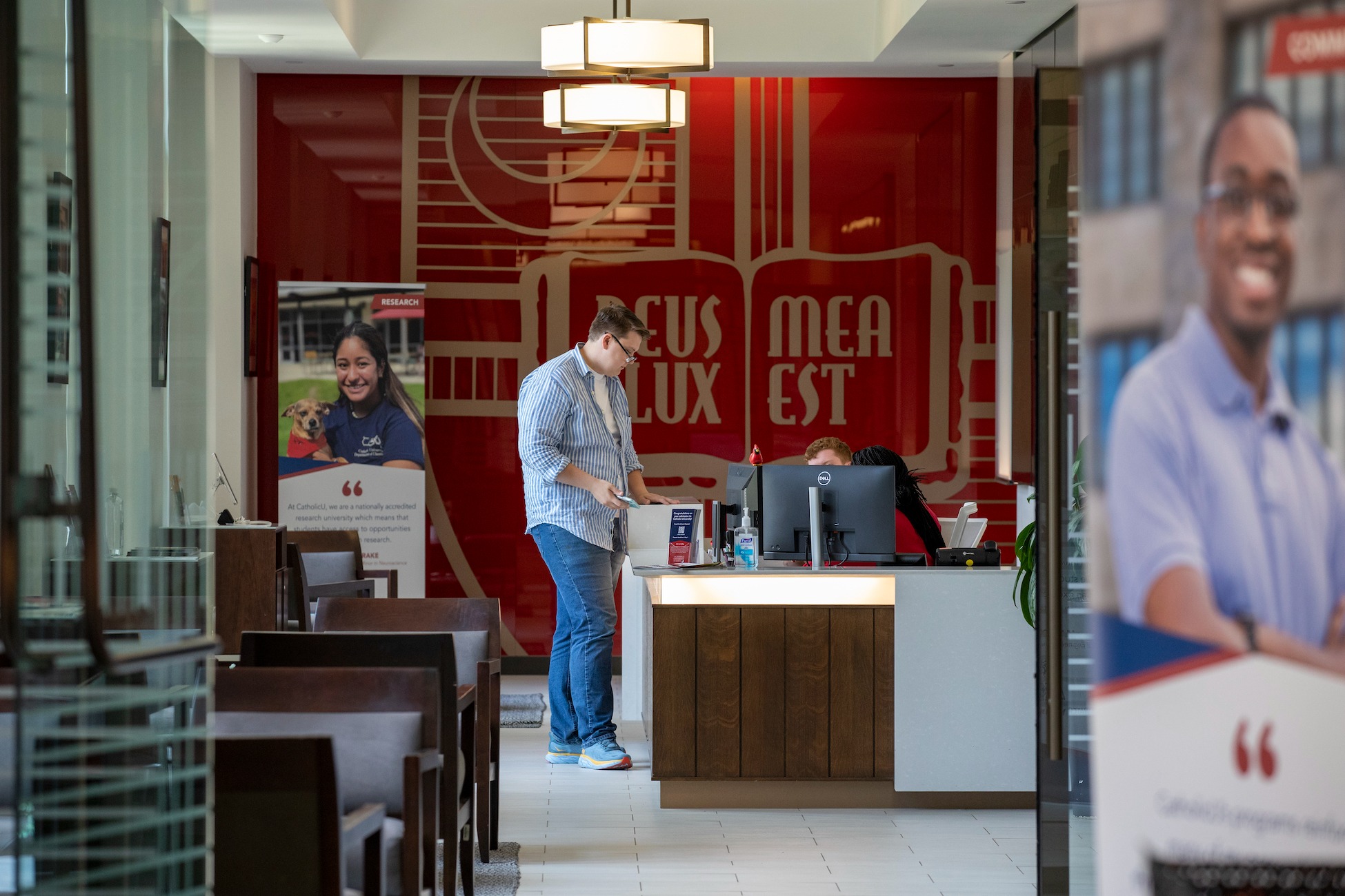 person talking with admissions front desk employee