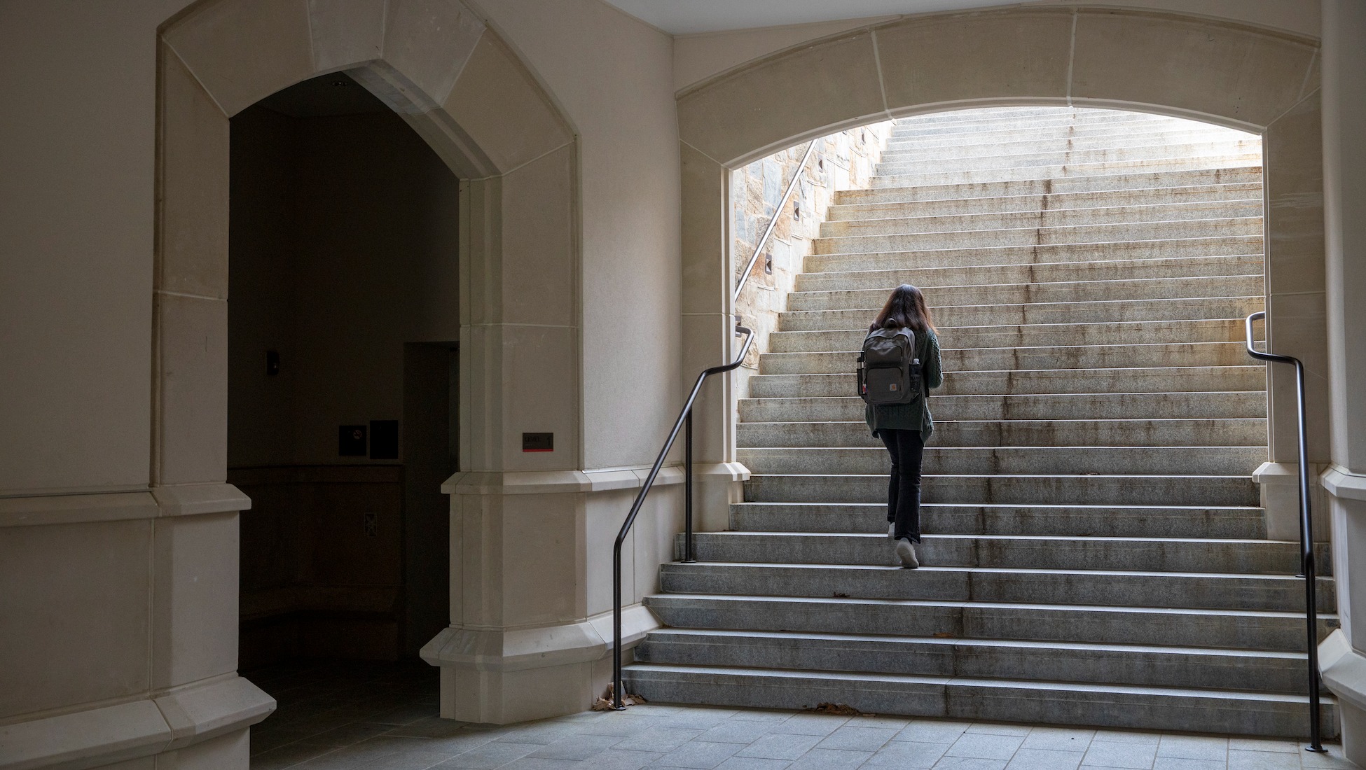 student walking up the steps of Garvey Hall