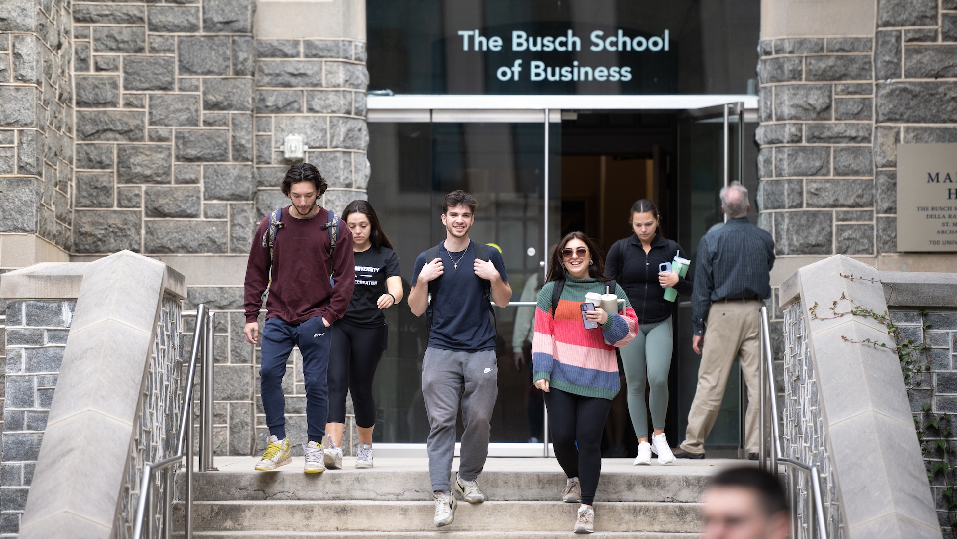 students walking out of the busch school of business building