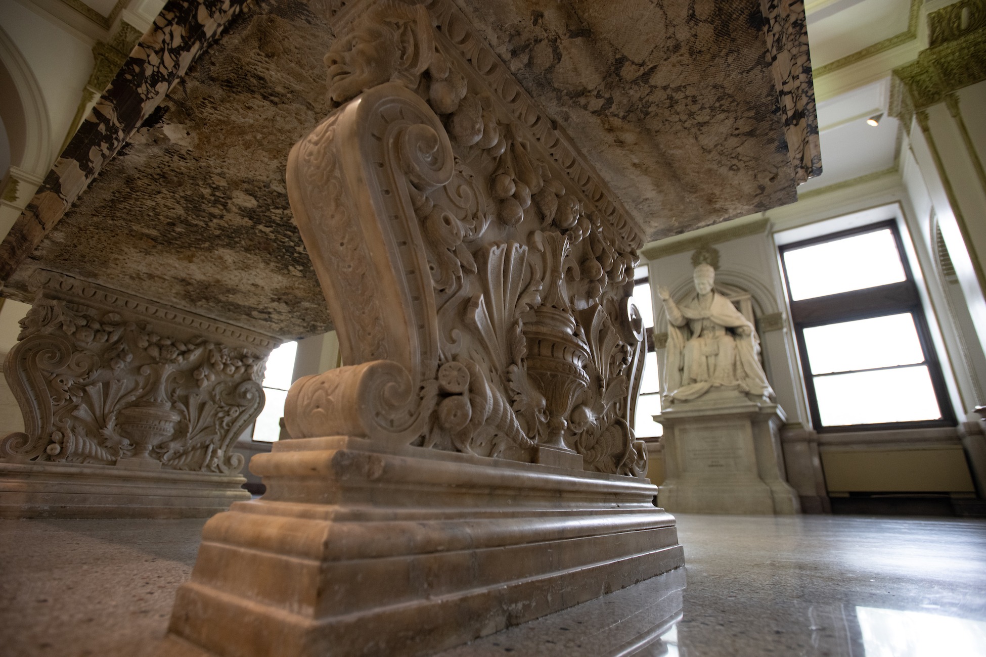 sculpted leg of a marbled table in mcmahon hall