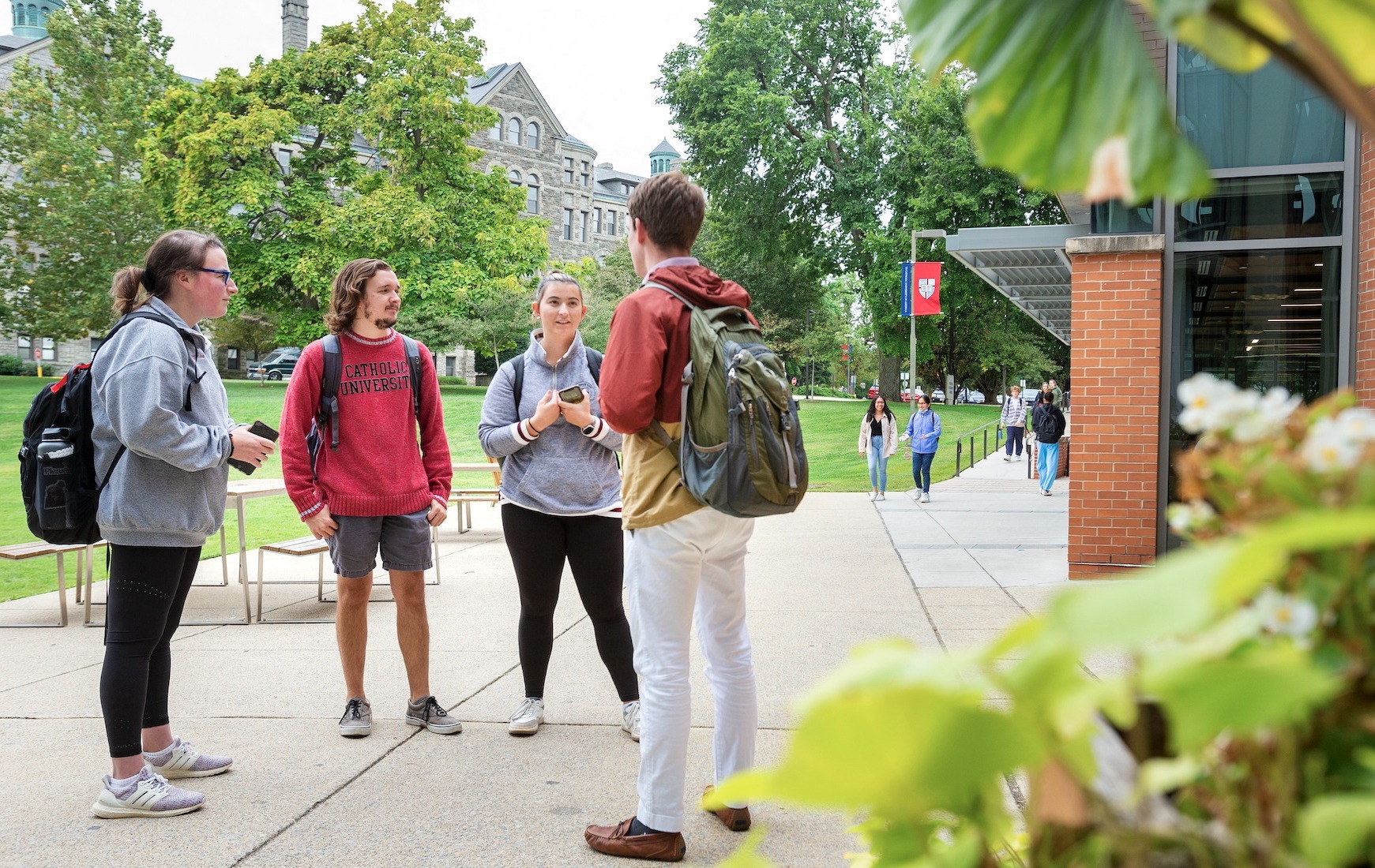 students talking together outside of a university building