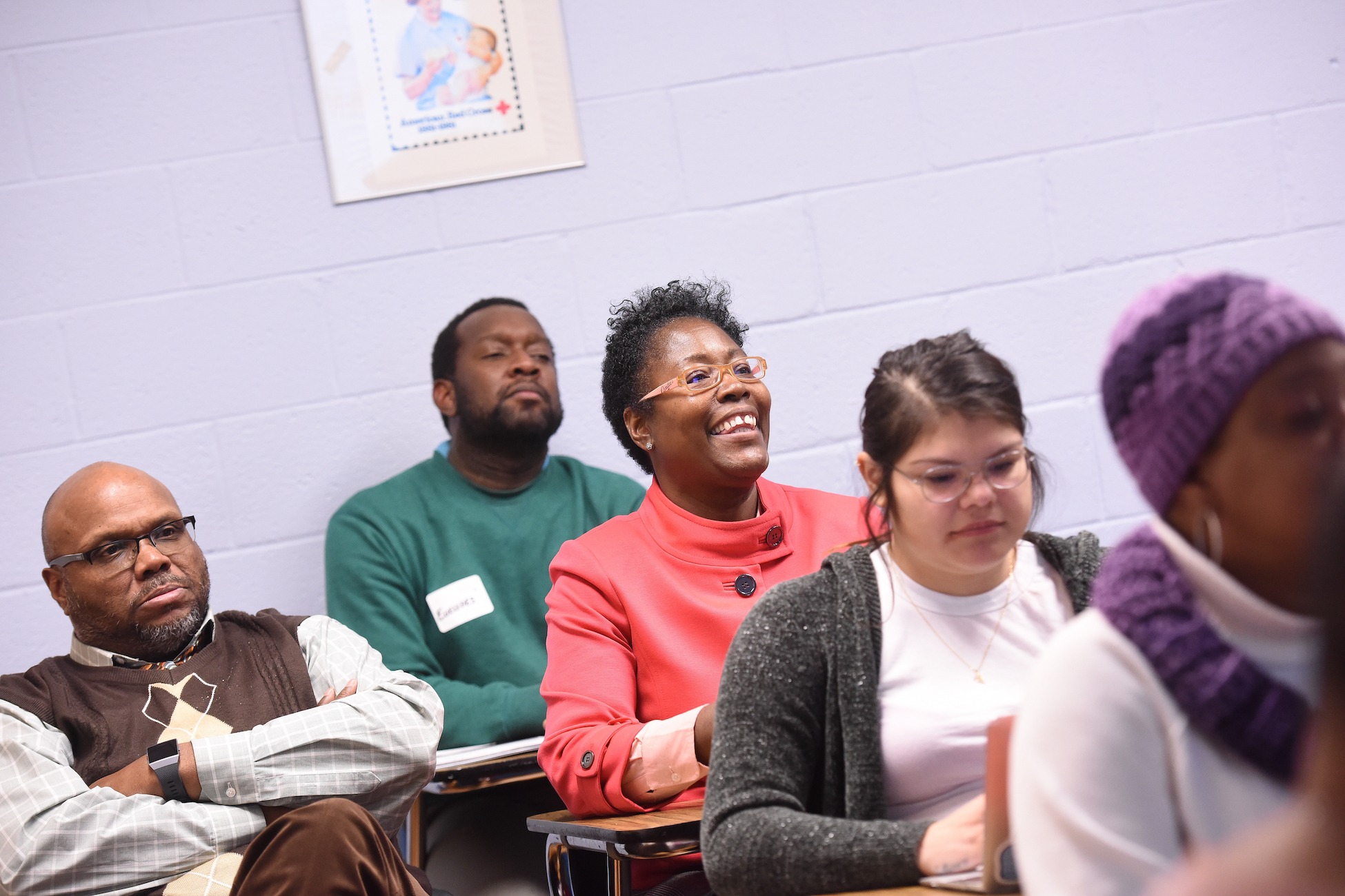 adult students smiling and paying attention in class