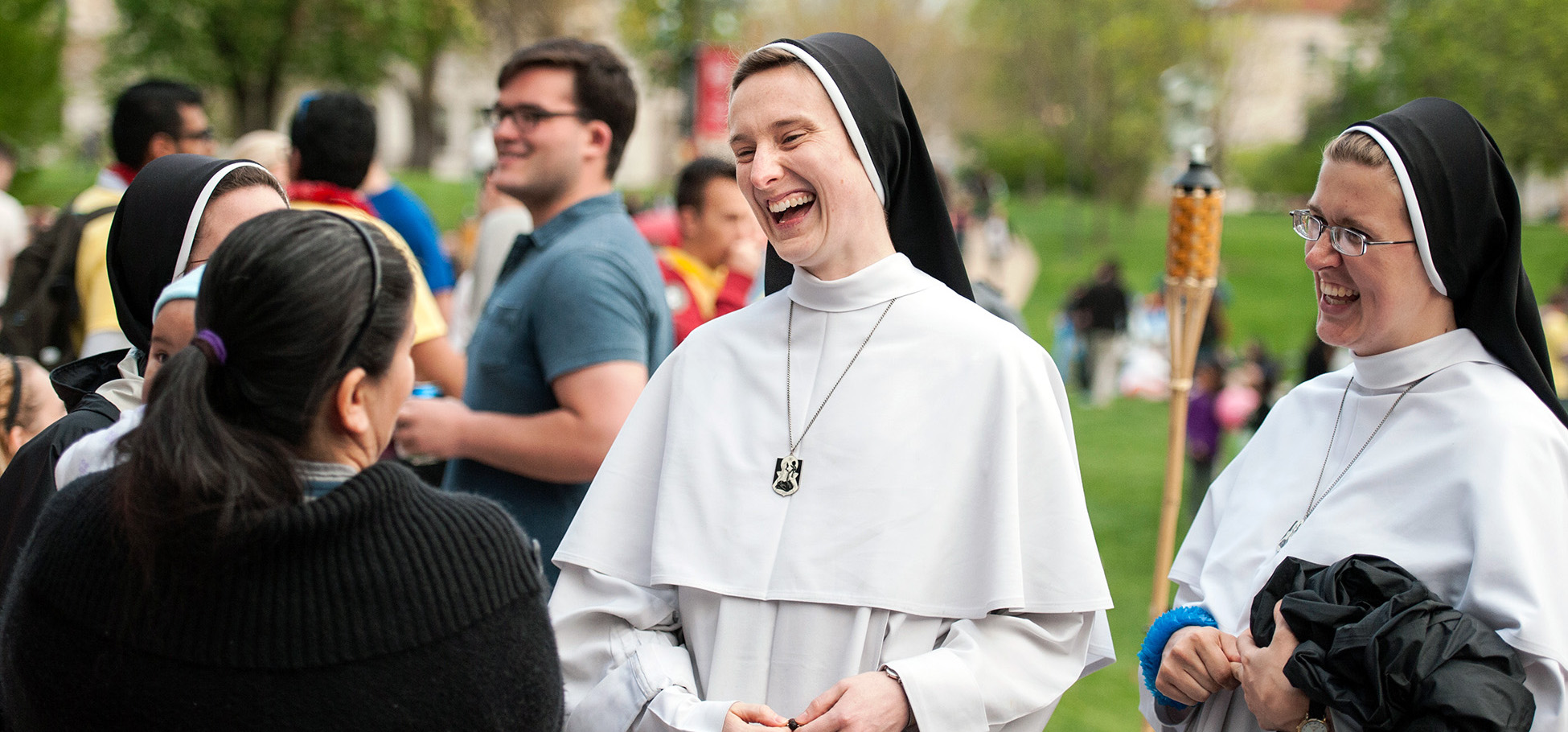 dominican sister laughing as she talks with a student