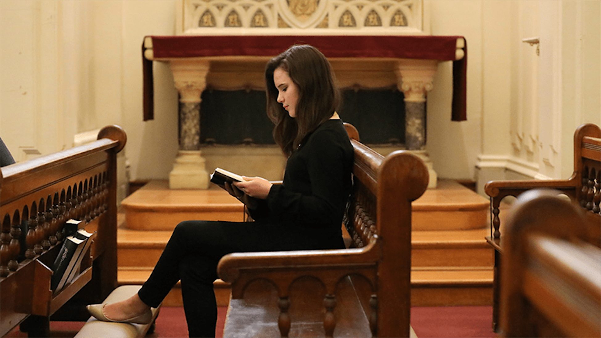 student reading in a chapel