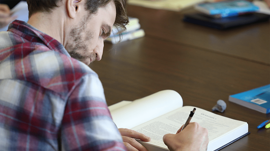 student annotating a book