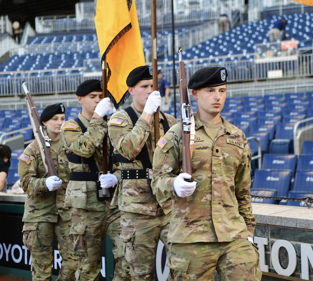 CUA color guard at a stadium