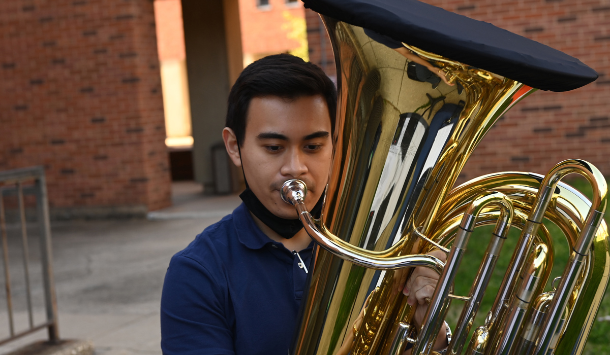 young man playing a tuba